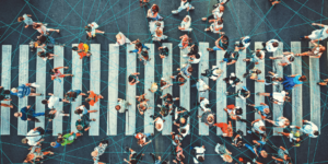 Birds eye view of people walking on a street, connected by a network.